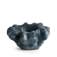 The Timna Coupe - Aged Iron by L’Objet is a sculptural ceramic bowl featuring a dark blue, organic silhouette with irregular, bumpy contours and a striking reactive glaze, shown against a plain white background.