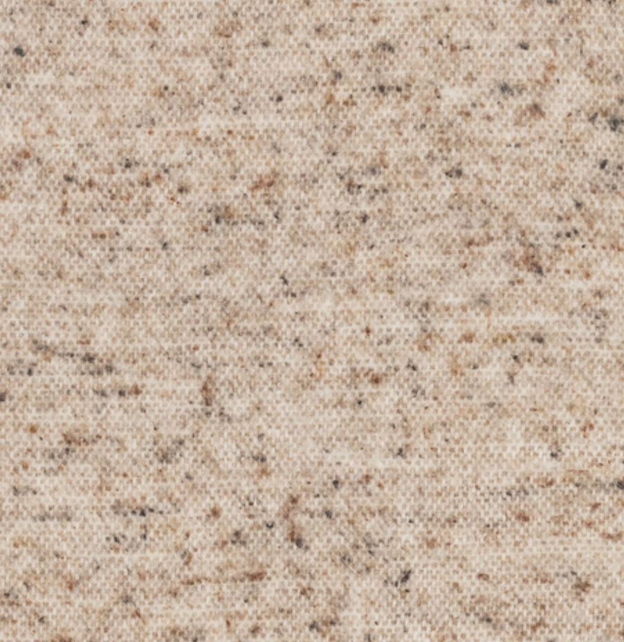 A close-up of the Cinder Mist Throw by Lands Downunder reveals a beige woven fabric with small brown and black flecks, featuring a modern, textured, and subtly speckled pattern reminiscent of premium Italian throw blankets.