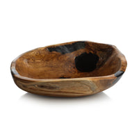 The Zodax Kenya Teakwood Bowl - 20" features an irregular shape, smooth polished finish, natural grain patterns, and a dark resin accent—ideal as a decorative fruit bowl or unique home décor piece.