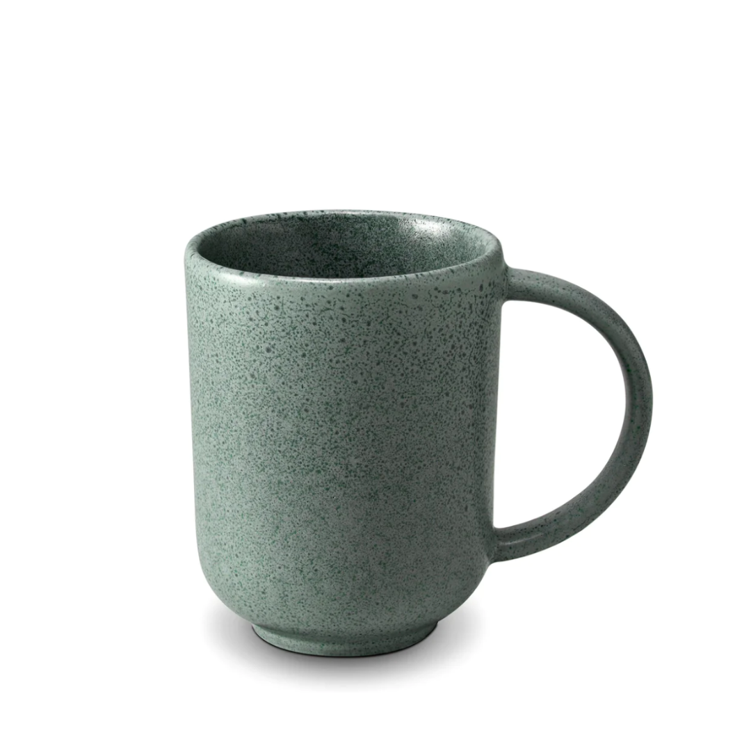 A speckled, matte green ceramic mug from L'Objet's Terra Seafoam Dinnerware collection with a large handle, shown on a plain white background.