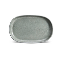 The L'Objet Terra Seafoam Dinnerware is a handcrafted, rectangular ceramic plate in shallow gray-green with rounded edges and a speckled finish, shown on a white background.