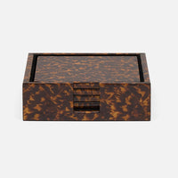 The Blue Pheasant Hartley Tortoise Coaster Set of 4 comes in a square, brown box with a tortoiseshell pattern, holding the luxury coasters stacked in a front slot against a light background.