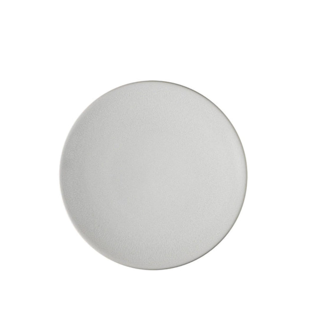 A plain, round, white ceramic plate from the Jars - Rosenthal Tourron Dinnerware Neige collection, handmade in France and photographed from above on a white background for a timeless look.