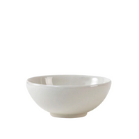 A plain white ceramic bowl with a glossy finish sits on a white background—part of the Tourron Dinnerware Neige collection by Jars - Rosenthal, renowned for its durable, handmade-in-France dinnerware.