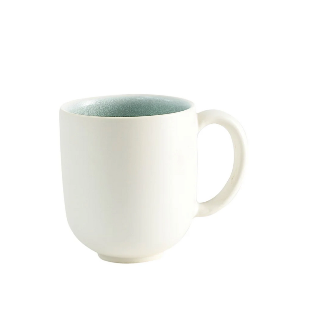 Cream-colored Tourron Dinnerware Eucalyptus mug with a light green interior, designed for modern everyday use.