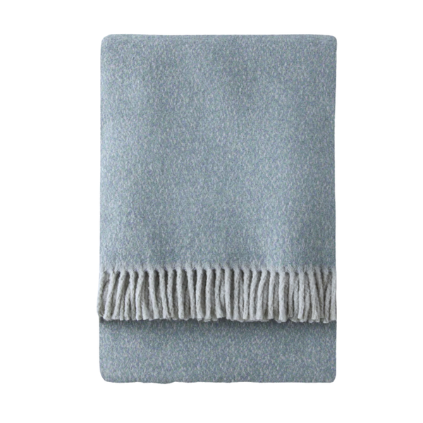 The A Soft Idea Tweed Weave Throw is neatly folded with a fringe along one edge and shown in light blue on a white background.