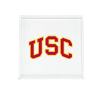 The Eye Candy College Acrylic Catchall Tray features a clear rectangular design with bold yellow USC letters outlined in red on a white base—an ideal, stylish accessory for any dorm room.