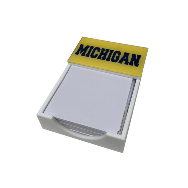 The Eye Candy College Note Pad is a white note holder with blank paper topped in yellow and labeled MICHIGAN in bold, navy blue letters—an ideal addition to any school note pad collection or as a graduation gift.
