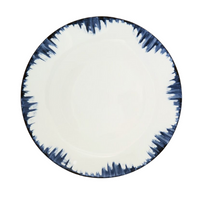 The Marie Daâge Iris 2 Dinnerware by Marie Daâge is a round ceramic plate with a white center and a dark blue, brushstroke-patterned rim, featuring a modern, artistic border inspired by hand-painted porcelain.