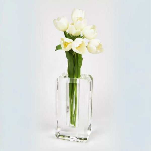 A bouquet of white tulips with green stems arranged in the Hex Edge Vase Large by Tizo, set against a plain, light background.