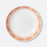 The Terra Rosa Dinnerware by Bernardaud features a white plate with orange and pink rectangle patterns encircling the rim. Made in Limoges, France.