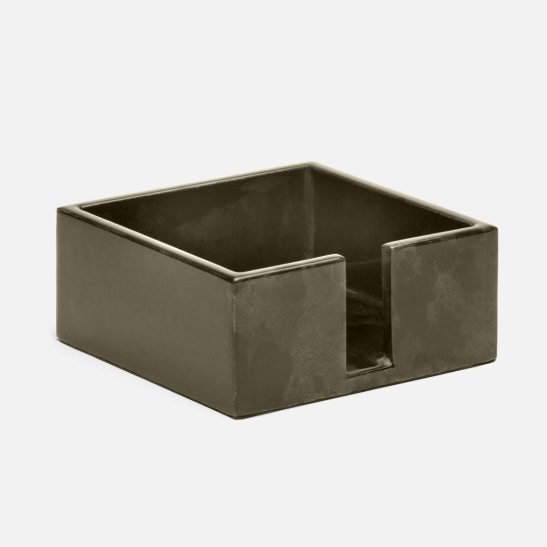 The Nelson Vellum Grey Cocktail Napkin Holder by Blue Pheasant is a square, grey leather accessory with an open front for storing and dispensing napkins—an elegant addition to any home bar, shown on a plain light background.