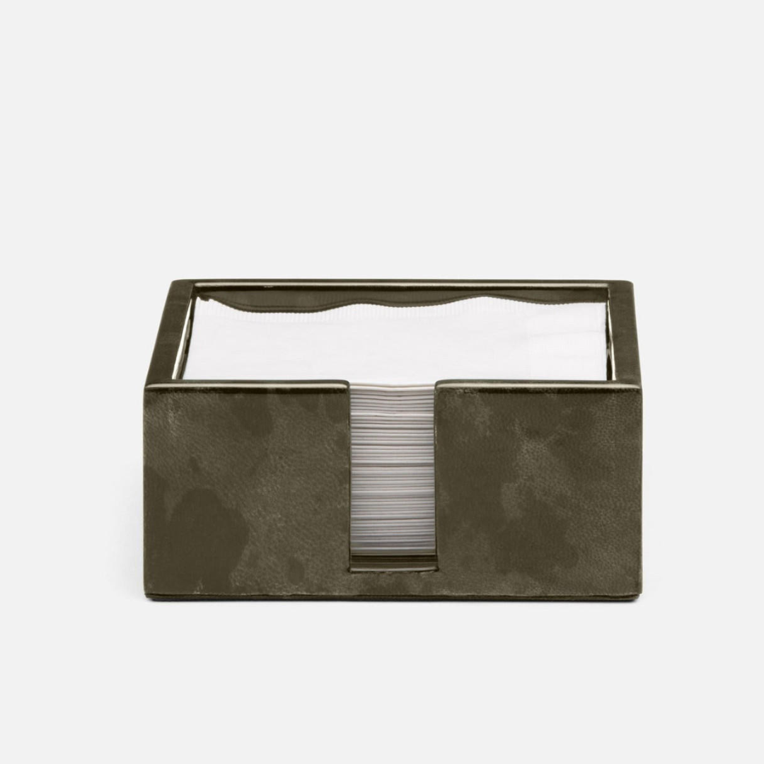 The Blue Pheasant Nelson Vellum Grey Cocktail Napkin Holder, shown with white napkins against a light background, makes an ideal home bar accessory.