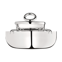 The Christofle Vertigo Silver Plated Caviar Set features a modern, minimalistic design with a polished silver finish, transparent glass section, and signature circular handle inspired by Andrée Putman's iconic Vertigo pattern.
