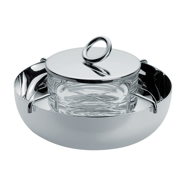 The Christofle Vertigo Silver Plated Caviar Set features Andrée Putman's iconic pattern, handles, a clear glass bowl, and a matching lid with a large circular handle, all shown against a white background.