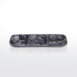 The Nashi Home Swirl Resin Classic 3 Section Tray features a rectangular black and white marbled design, shatter-resistant, food-safe resin, with three compartments. Shown on a reflective white surface with a plain background.