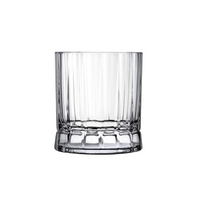 A set of four Wayne DOF glasses by Nude Glassware, crafted from lead-free crystal with vertical ribbed sides and a faceted base, is displayed against a white background.