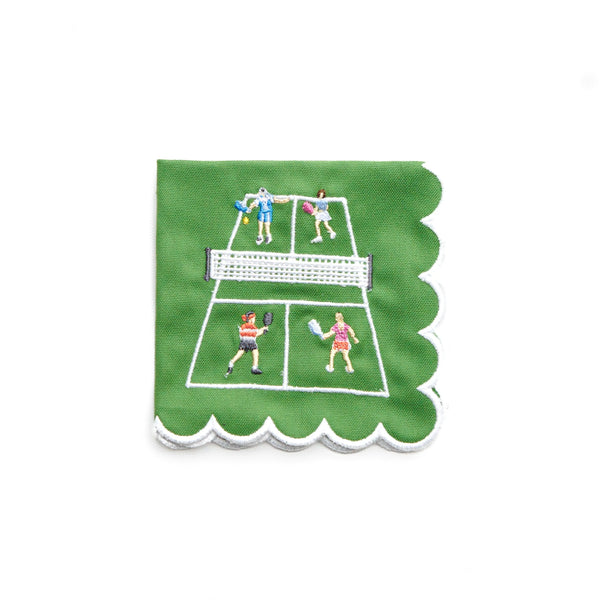 Pomegranate’s Day At The Courts Cocktail Napkin Set of 4 features green cotton napkins with scalloped white borders, embroidered with four people playing tennis—ideal for adding playful charm to any gathering.