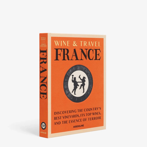 Assouline's "Wine & Travel France" features an orange cover with a black and white medallion and the subtitle: "Discovering French vineyards, the country's top wines, and the true essence of terroir.