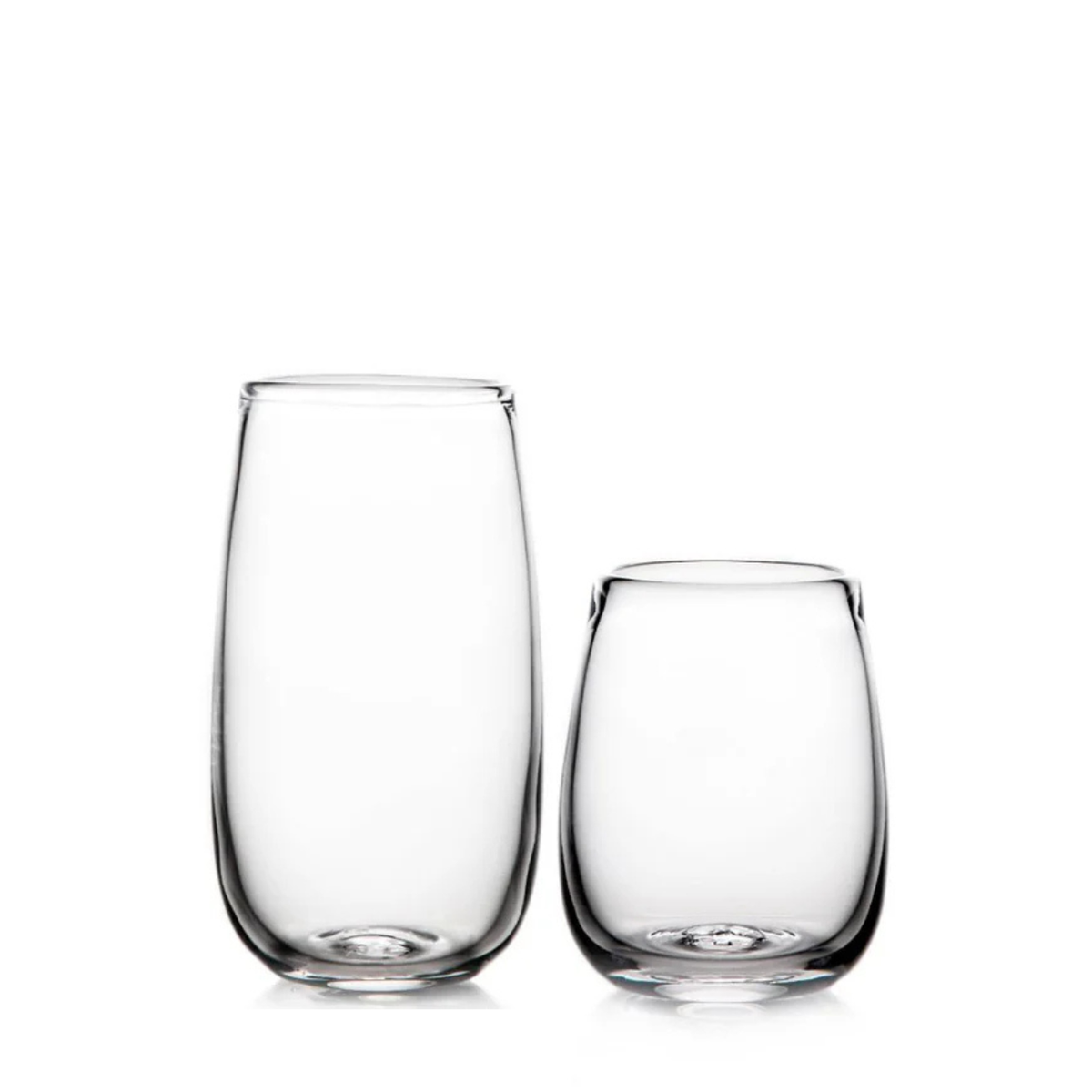 Two clear, stemless Simon Pearce Woodstock Tumblers are side by side on a white background—one taller, one shorter—both lead-free and featuring smooth, rounded shapes.