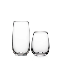 Two clear, stemless Simon Pearce Woodstock Tumblers are side by side on a white background—one taller, one shorter—both lead-free and featuring smooth, rounded shapes.
