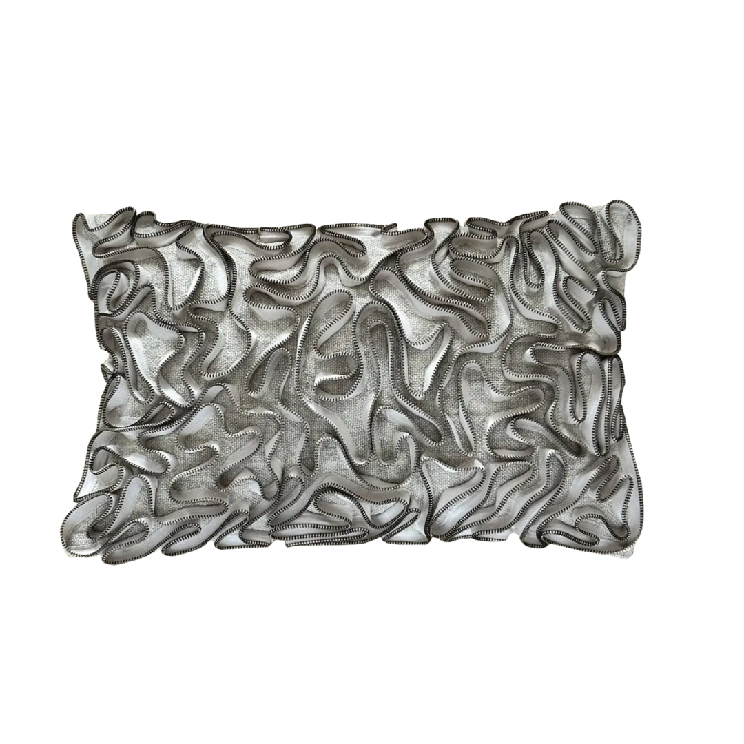 The Threads Soft Goods Zipper Pillow Natural 13 x 20 is a rectangular, handcrafted pillow with a white base and textured black embroidered wavy lines and loops in an abstract ribbon pattern.