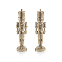Two identical metallic Nutcracker Gold Statue figurines stand side by side.