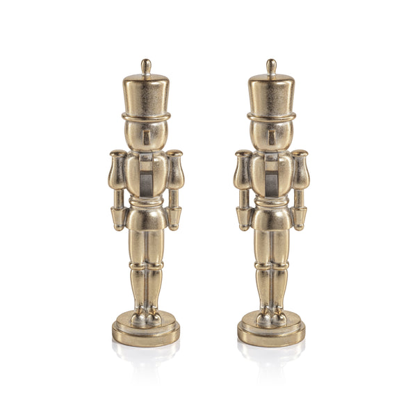Two identical metallic Nutcracker Gold Statue figurines stand side by side.