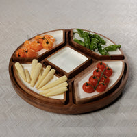 The Zodax Walden 5 Section Lazy Susan, a round serving tray with white ceramic compartments, organizes yellow baby corn, cherry tomatoes, orange peppers, and green peppers on a light patterned surface.