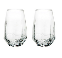 The Gemstone Highball Set of 2 by Vista Alegre features modern, geometric glasses with thick bases and faceted clear glass. Stylish and contemporary, these dishwasher-safe tumblers are perfect for any setting.