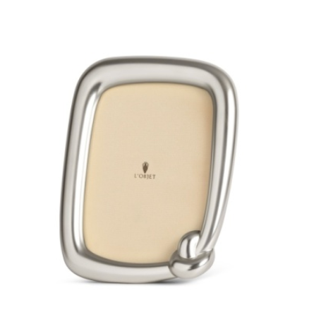 Rectangular platinum Jessica McCormack Knot Frame Platinum - with rounded corners and a signature knot detail at the bottom right.