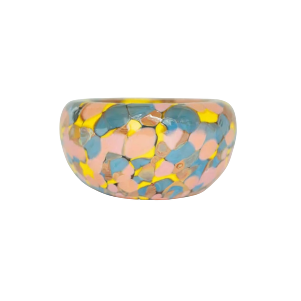 The Jelly Baby Bubble Bowl by Maria Ida Designs features a glossy, chunky dome shape adorned with a vibrant mosaic pattern in pink, blue, and yellow hues—evoking the lively aesthetic of art glass pieces—and is beautifully displayed against a white background.