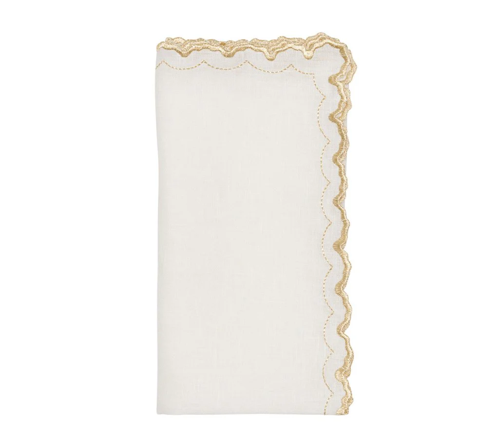 The Arches Napkin Set of 4 by Kim Seybert features white linen with scalloped gold embroidery and a subtle geometric design, blending elegance and modern style.