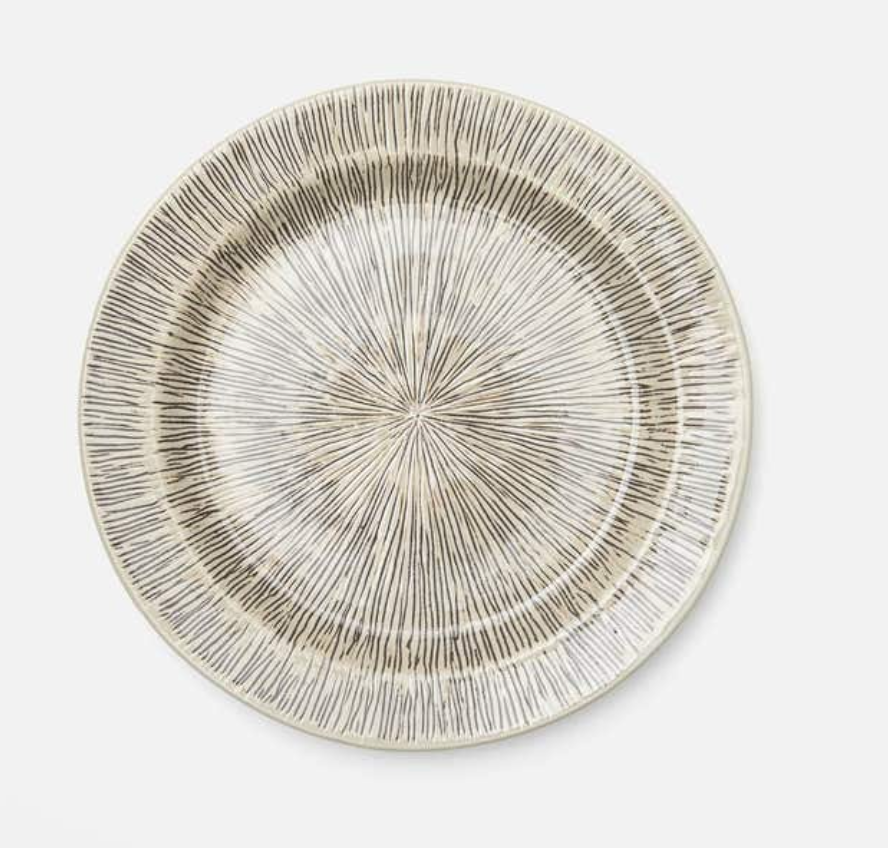 The Nolan Dinnerware Black Cream plate by Blue Pheasant is a round ceramic piece with a beige base, sleek black starburst lines, a slightly raised rim, and glossy finish—ideal for elevating any handpainted tabletop.
