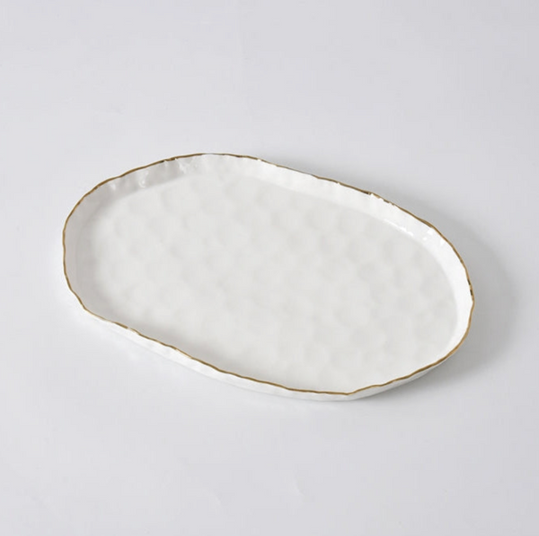 The PAMPA BAY Portofino Oval Platter, crafted from textured white porcelain and accented with a gold trim, rests elegantly on a white background.