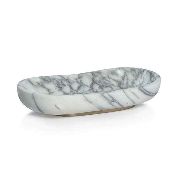 The Zodax Arebascato Oval Marble Bowl On Gold Base features gray veining, smooth rounded edges, and a polished finish. Its shallow design rests elegantly on a small gold base for a sophisticated decorative touch.