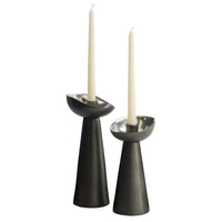 Two sculptural Argemone Candleholder Set of 2 - Black by Arteriors, each with a modern blackened bronze finish, silver accents, and a unique bowl-shaped top holding tall white taper candles.