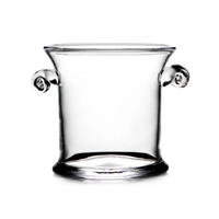 The Simon Pearce Norwich Ice Bucket, handcrafted from glass with two spiral handles, is shown against a white background.