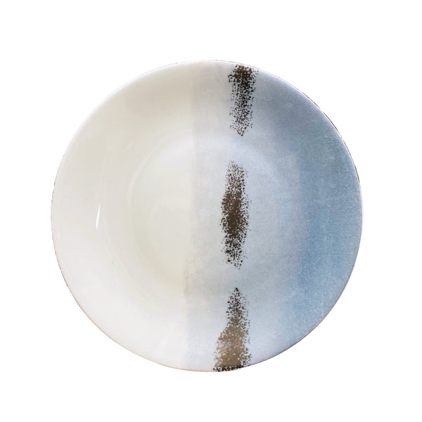 The Maarie Daâge Horizon Platinum Dinnerware by Marie Daâge is a round ceramic plate made in France, featuring a white and light blue gradient with two vertical brown textured stripes near the center.