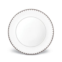 A round white L'Objet Aegean Filet Platinum Dinnerware plate, featuring a platinum scalloped border, is shown from above on a white background—an elegant piece from the L'Objet collection.