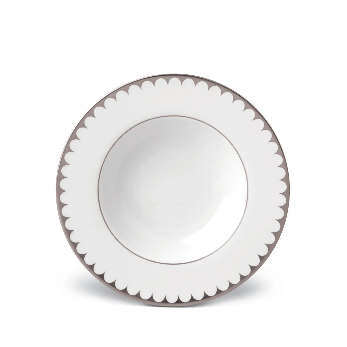 A white ceramic bowl with a scalloped gray-edged rim, viewed from above on a white background, reflects the refined elegance of L’Objet’s Aegean Filet Platinum Dinnerware.