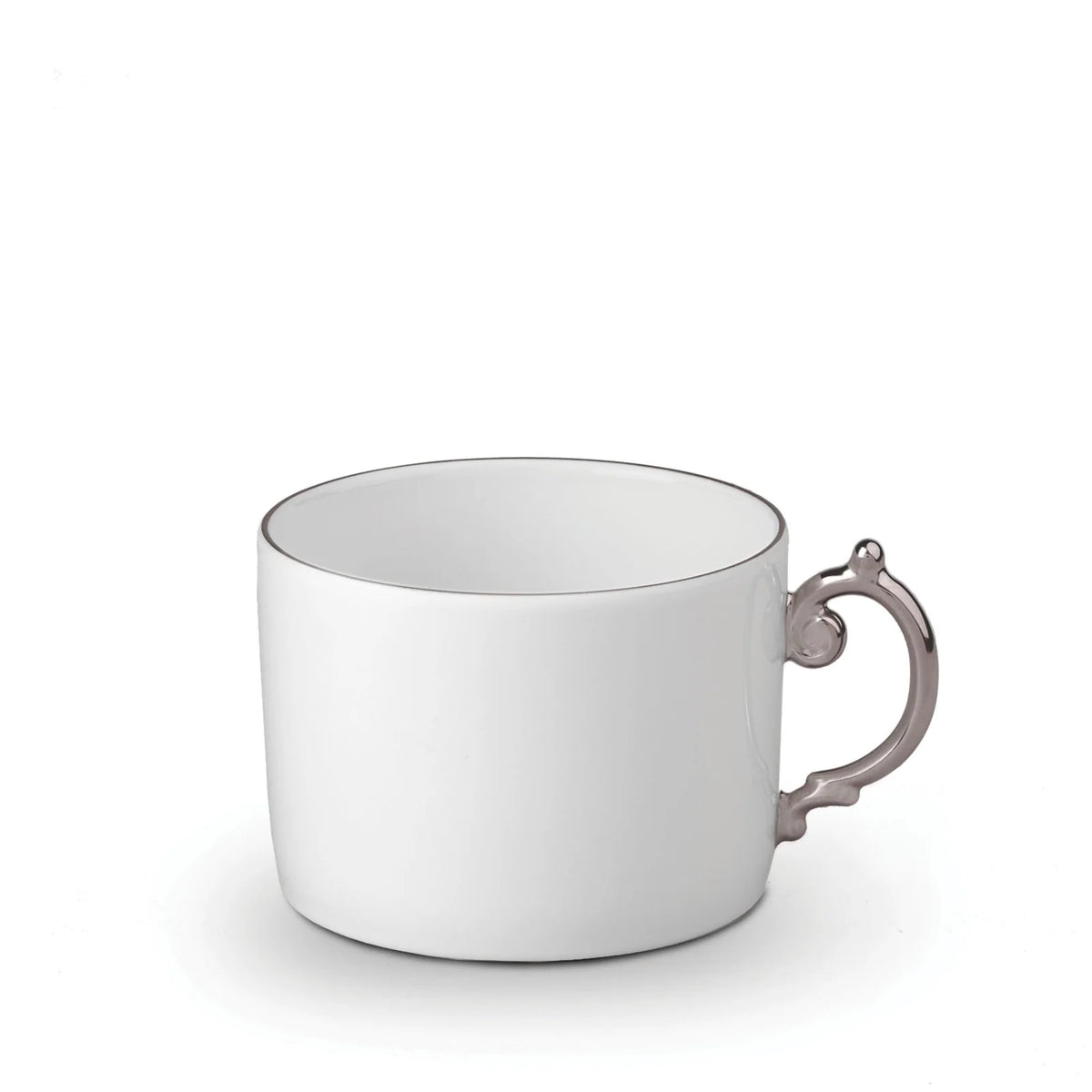 L’Objet Aegean Filet Platinum Dinnerware white porcelain teacup with a thin silver rim and a decorative silver handle with platinum accents.