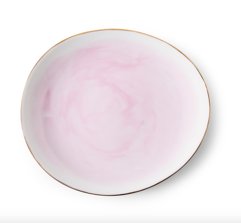 The Galette Dinnerware plate by Molecot is a round hand-painted porcelain piece with a soft pink marbled pattern and a thin gold rim, shown on a white background.