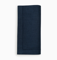 A set of four navy blue Festival Napkins by Sferra, crafted from European linen with elegant white stitching.