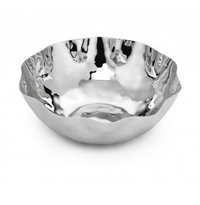 The Blossom Stainless Steel Bowl by Mary Jurek features a reflective hammered finish and a scalloped, uneven rim. Dishwasher safe, it sits elegantly against a white background.