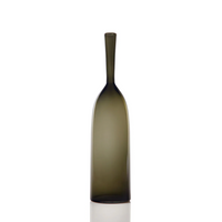 The Cariati Angelic Bottle - Small - is a tall, slender olive-green glass bottle with a long neck and smooth finish, standing upright on a white background.