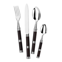 The Alain Saint-Joanis Carla Flatware Ebony 5 Piece Setting features dark handles and silver accents, with a fork, knife, tablespoon, teaspoon, and salad fork displayed side by side on a white background.