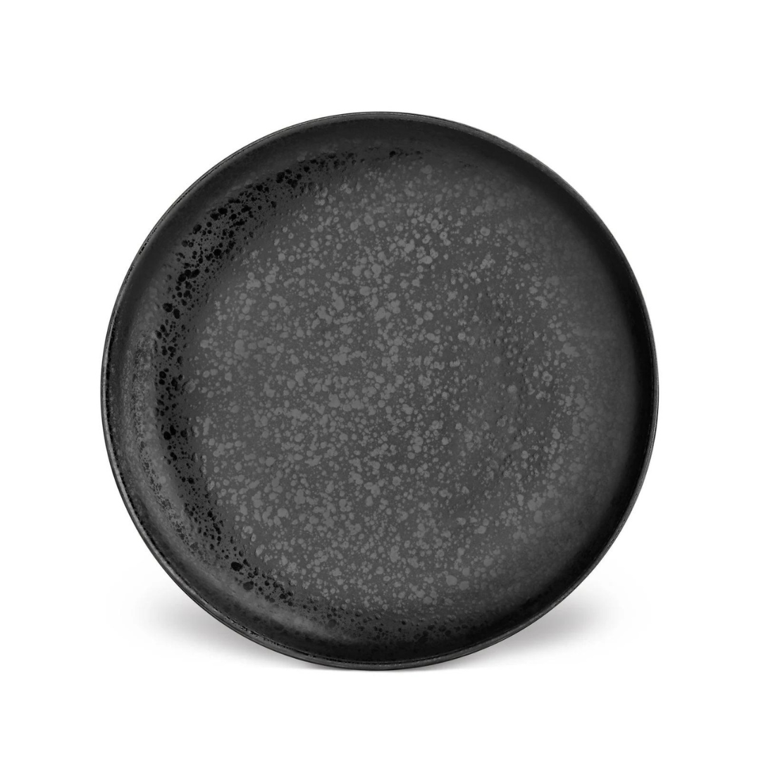The Alchimie Dinnerware Black by L'Objet is a round, black ceramic plate with a matte finish and subtle speckled pattern, evoking refined style and shown against a plain white background.