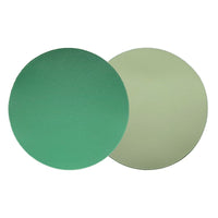 Two round, flat Grained Faux Leather Reversible Placemats by Von Gern Home—one green, one light beige—overlap on a plain white background, highlighting the dual-sided design perfect for elegant tables. Set of 4.
