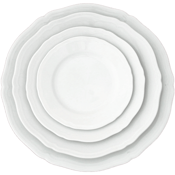 Three stacked white Ginori 1735 Antico Doccia dinner plates with scalloped rims and timeless style, viewed from directly above.